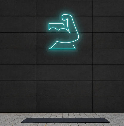 Image of a stylish strong body neon sign in ice blue mounted on gym wall.