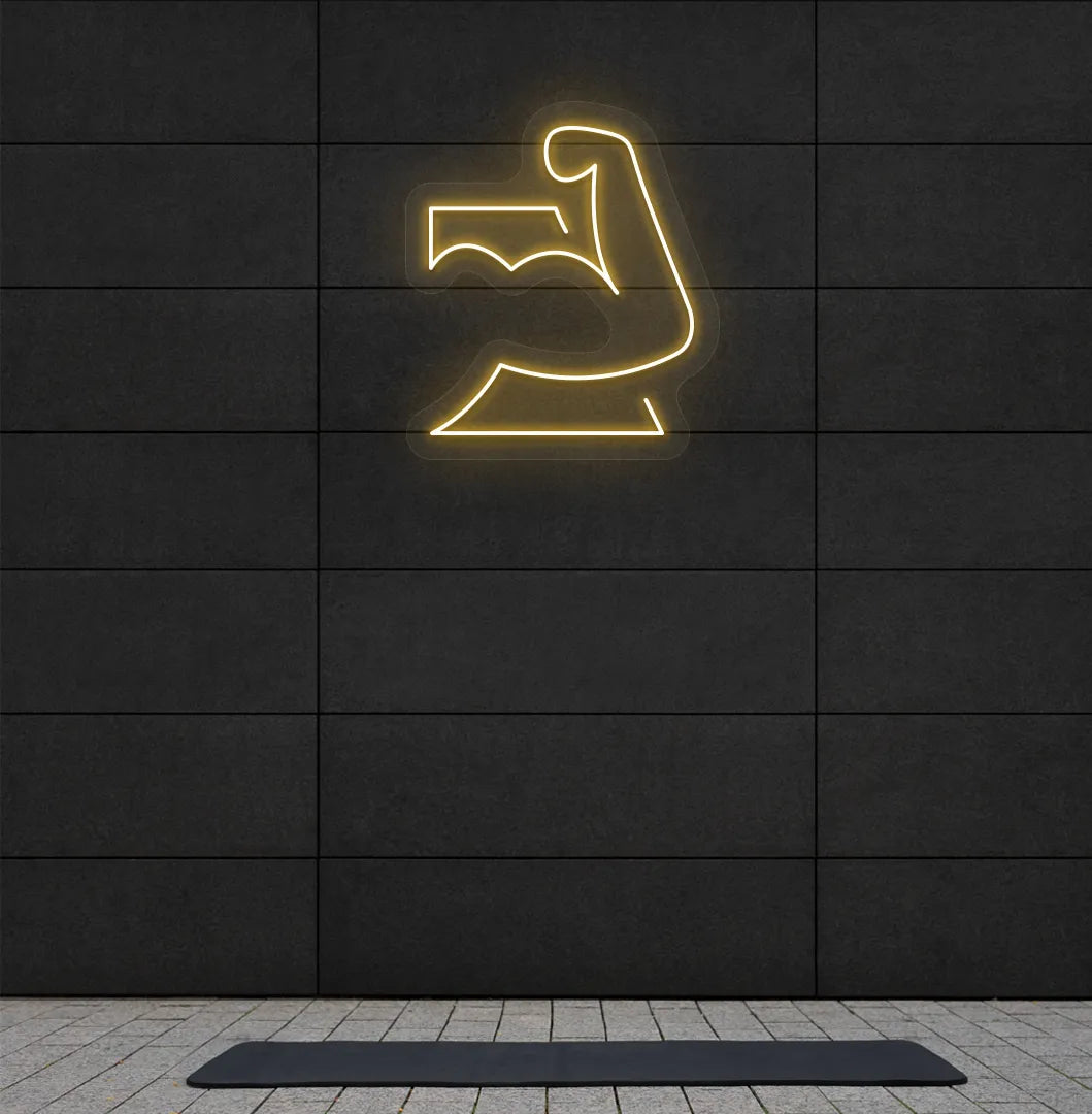 Trendy strong body neon sign in orange mounted on fitness wall.