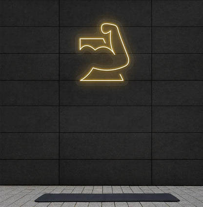 Trendy strong body neon sign in orange mounted on fitness wall.