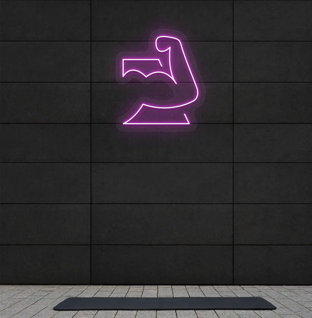 Image of a stylish strong body neon sign in pink mounted on gym wall.