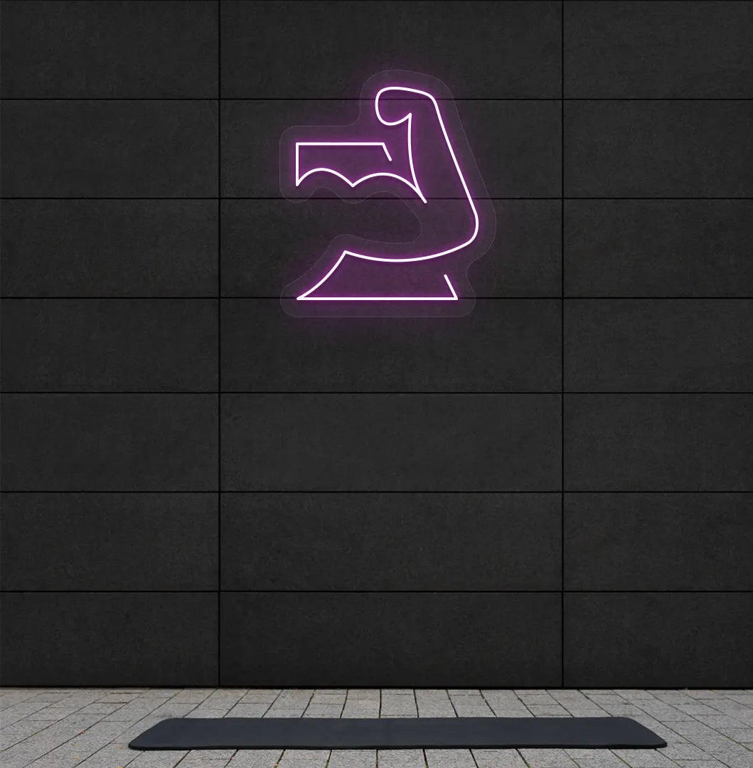 Trendy strong body neon sign in purple mounted on fitness wall.