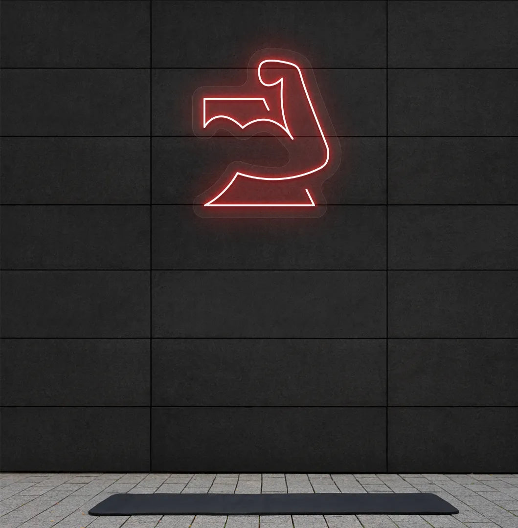 Image of a stylish strong body neon sign in red mounted on gym wall.