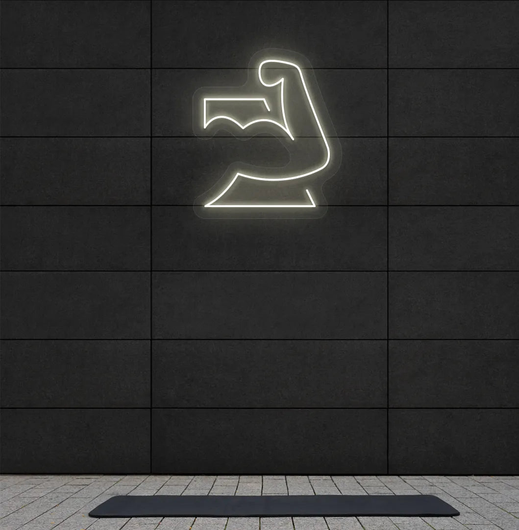 Trendy strong body neon sign in warm white mounted on fitness wall.