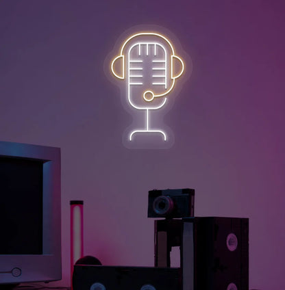 Stylish studio MIC neon sign in orange mounted on gaming room wall.