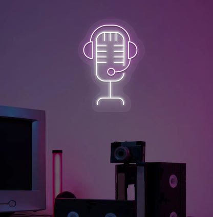 Stylish studio MIC neon sign in purple mounted on gaming room wall.