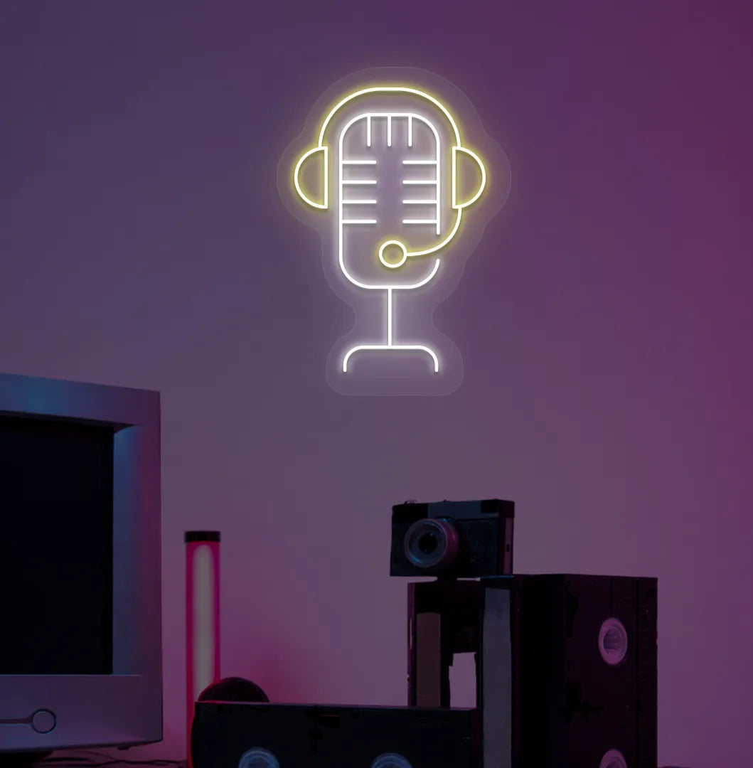 Stylish studio MIC neon sign in yellow mounted on gaming room wall.