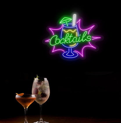 Modern wall decor with cocktail text and glass neon sign glowing green.