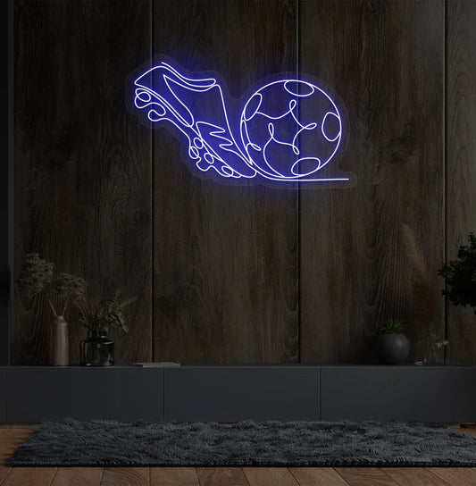 Image of a "Football with shoe" neon sign glowing blue on sports-themed wall.