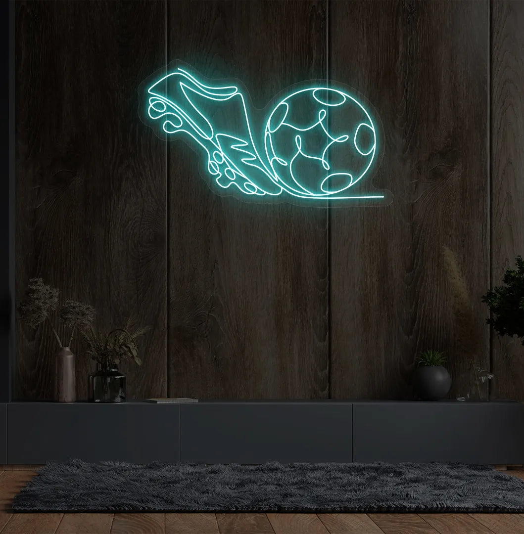 Image of a "Football with shoe" neon sign glowing ice blue on sports-themed wall.