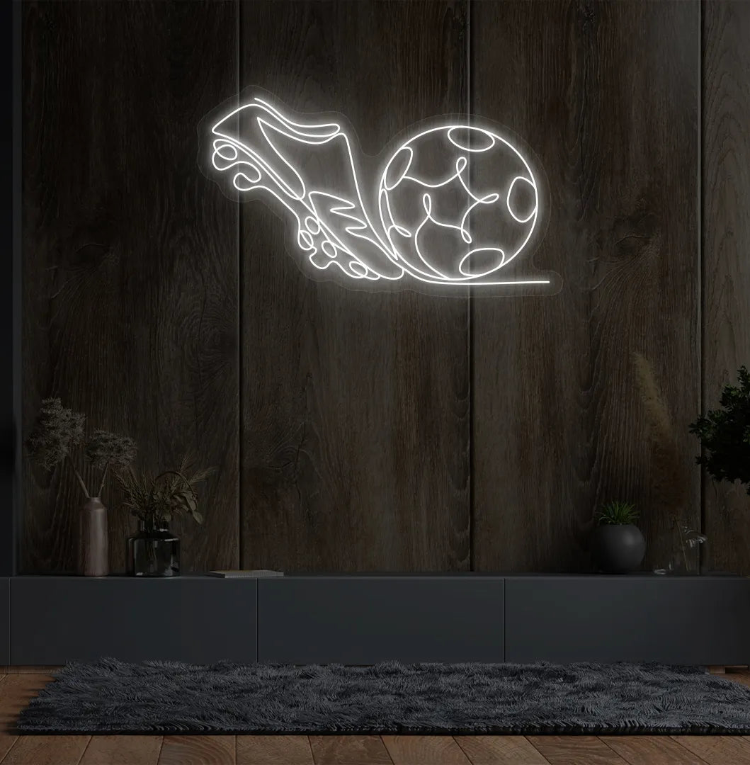 Image of a "Football with shoe" neon sign glowing white on sports-themed wall.