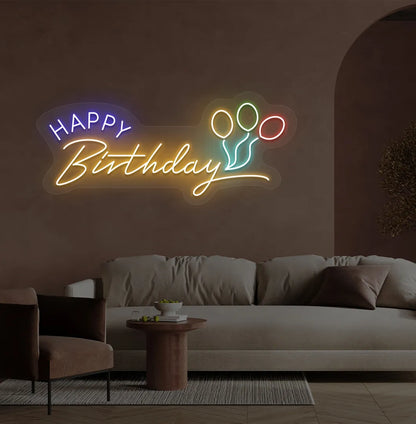 Stylish Happy Birthday LED neon sign glowing orange for celebration backdrop.