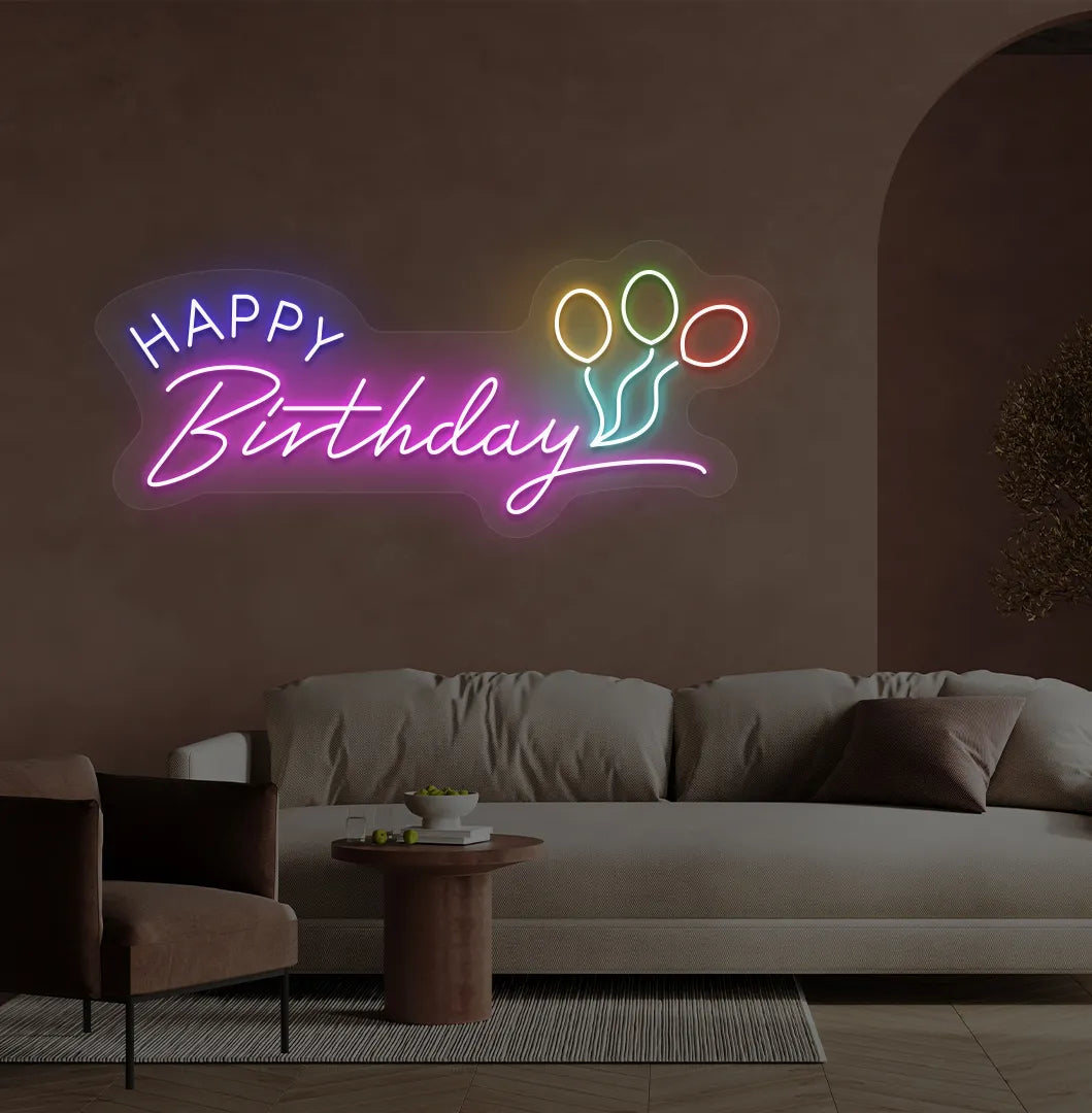Trendy Happy Birthday neon sign in pink mounted on decorative party wall.