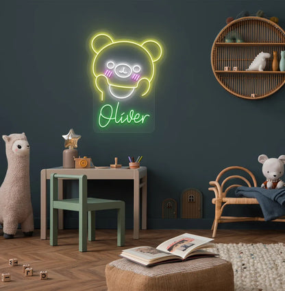 Teddy Bear Nursery Name neon sign glowing green on decorative wall.