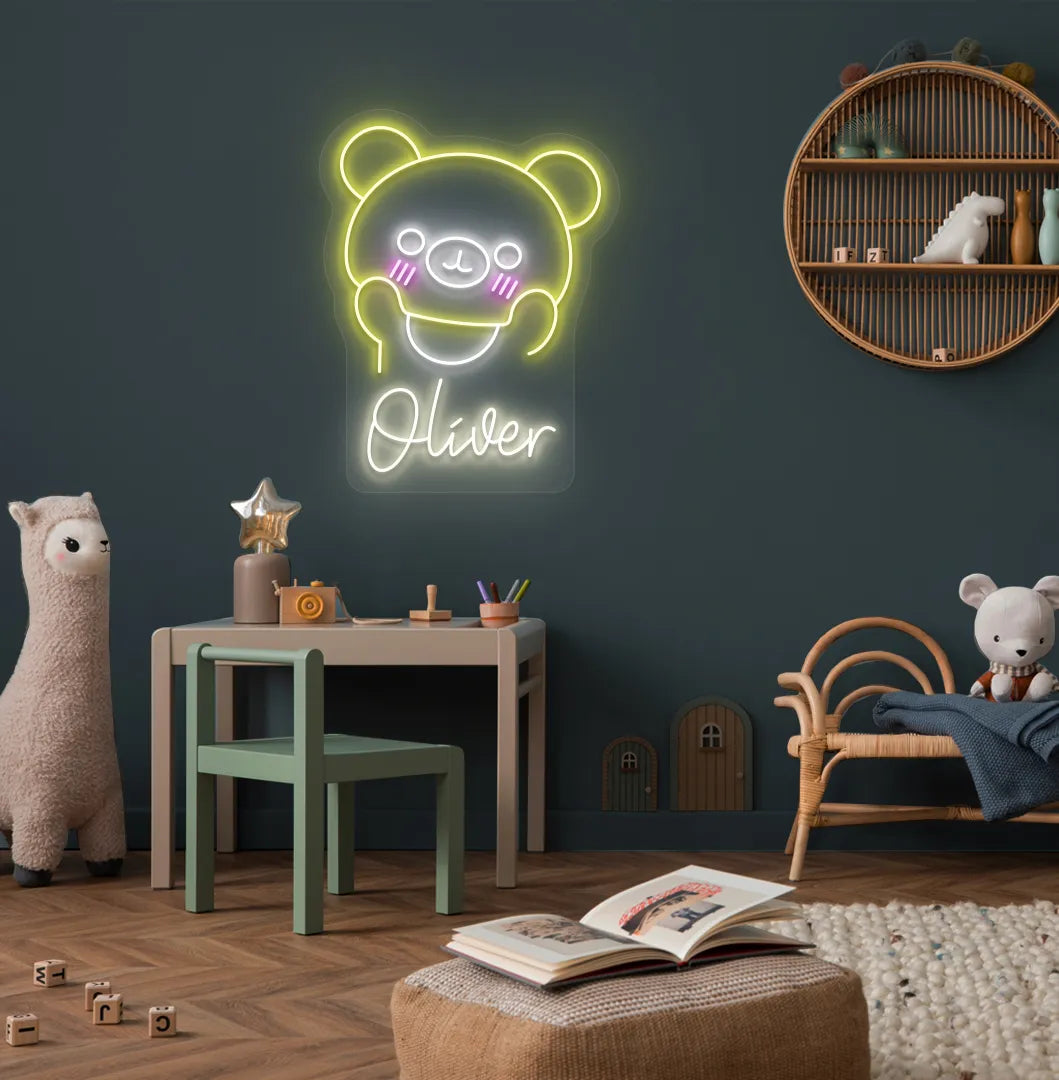 Teddy Bear Nursery Name neon sign glowing warm white on decorative wall.