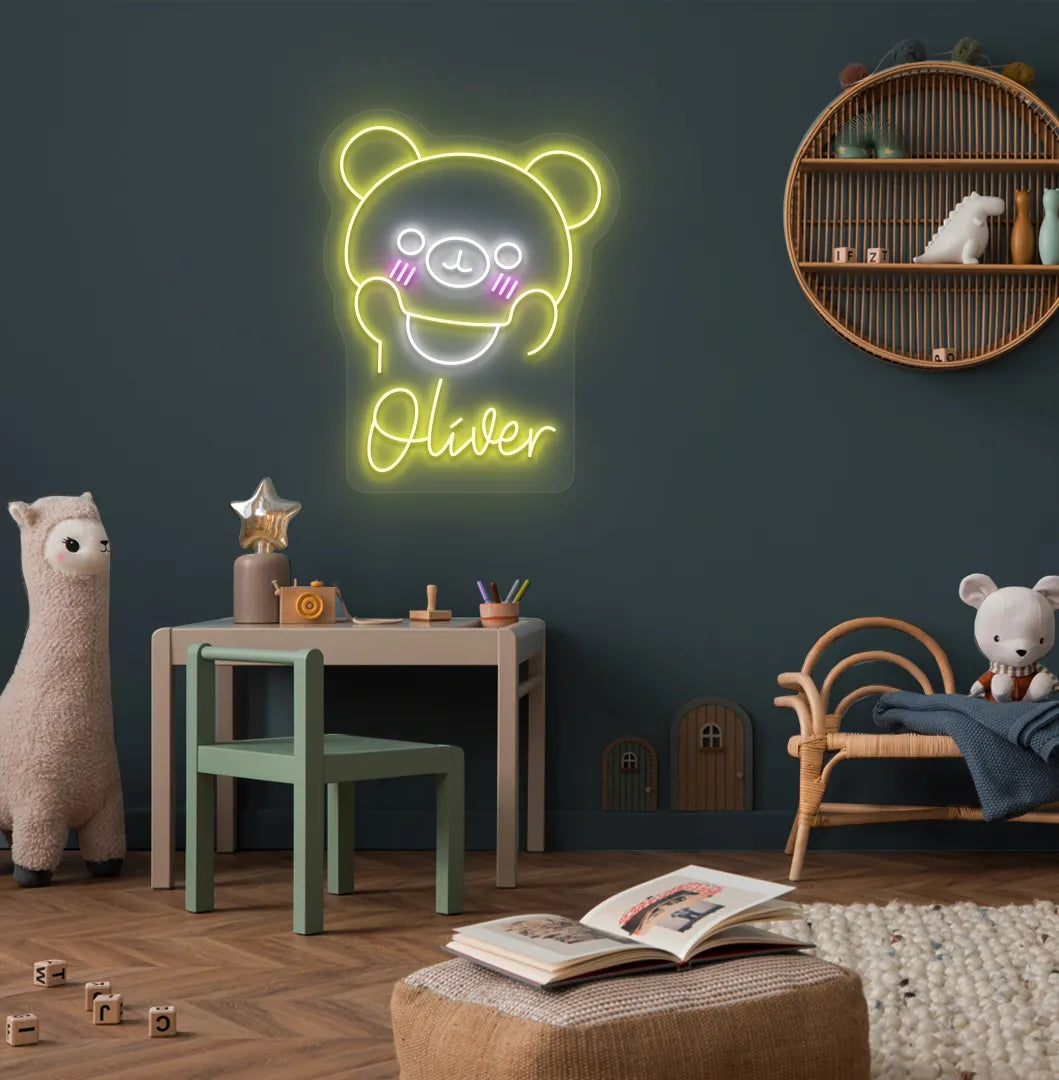 Teddy Bear Nursery Name neon sign glowing yellow on decorative wall.