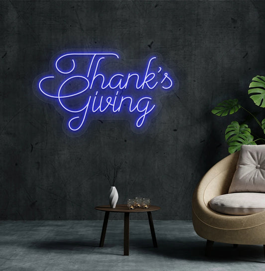 Image of a Thanksgiving neon sign mounted on an aesthetic living room wall in blue color.