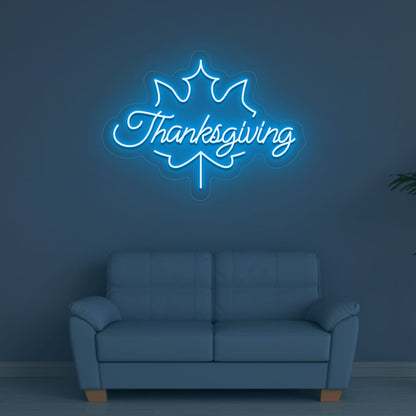 An image of a Thanksgiving neon sign in ice blue is displayed on a wall, suitable for home decor and various environments.