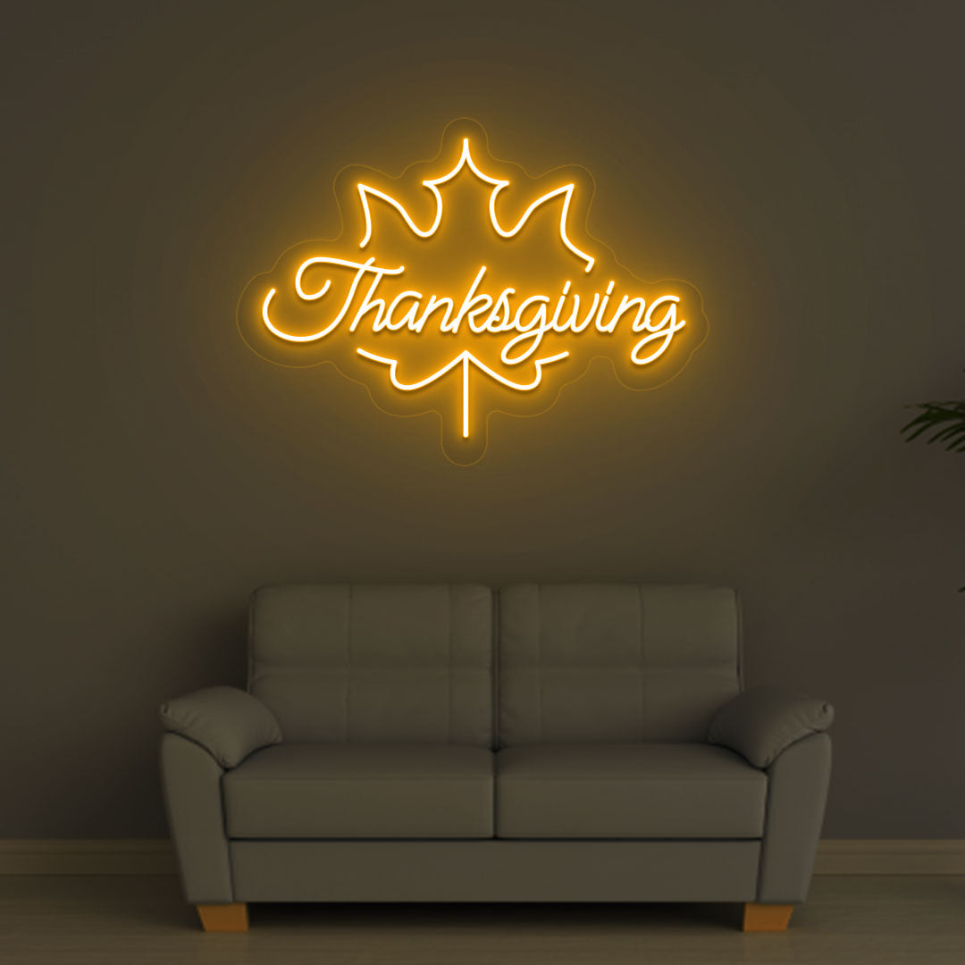 An image of a Thanksgiving neon sign in orange is displayed on a wall, suitable for home decor and various environments.