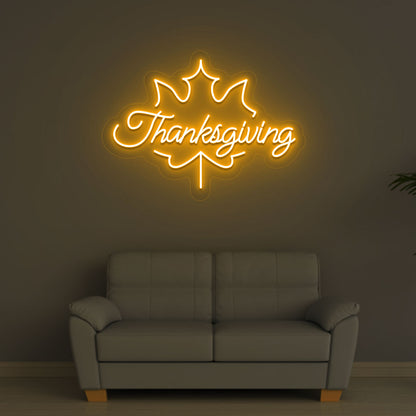 An image of a Thanksgiving neon sign in orange is displayed on a wall, suitable for home decor and various environments.