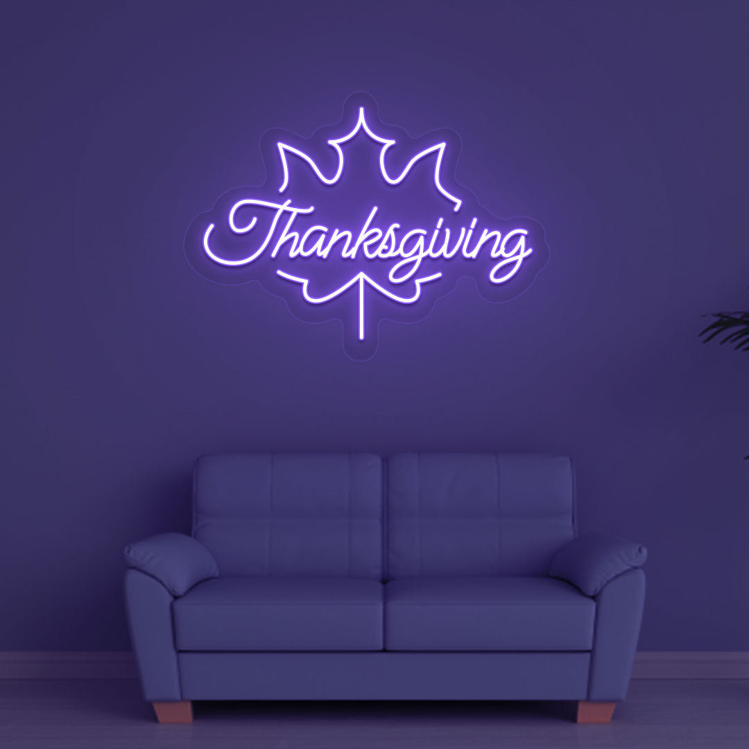 Festive season with a Thanksgiving purple neon sign glowing on a wall.