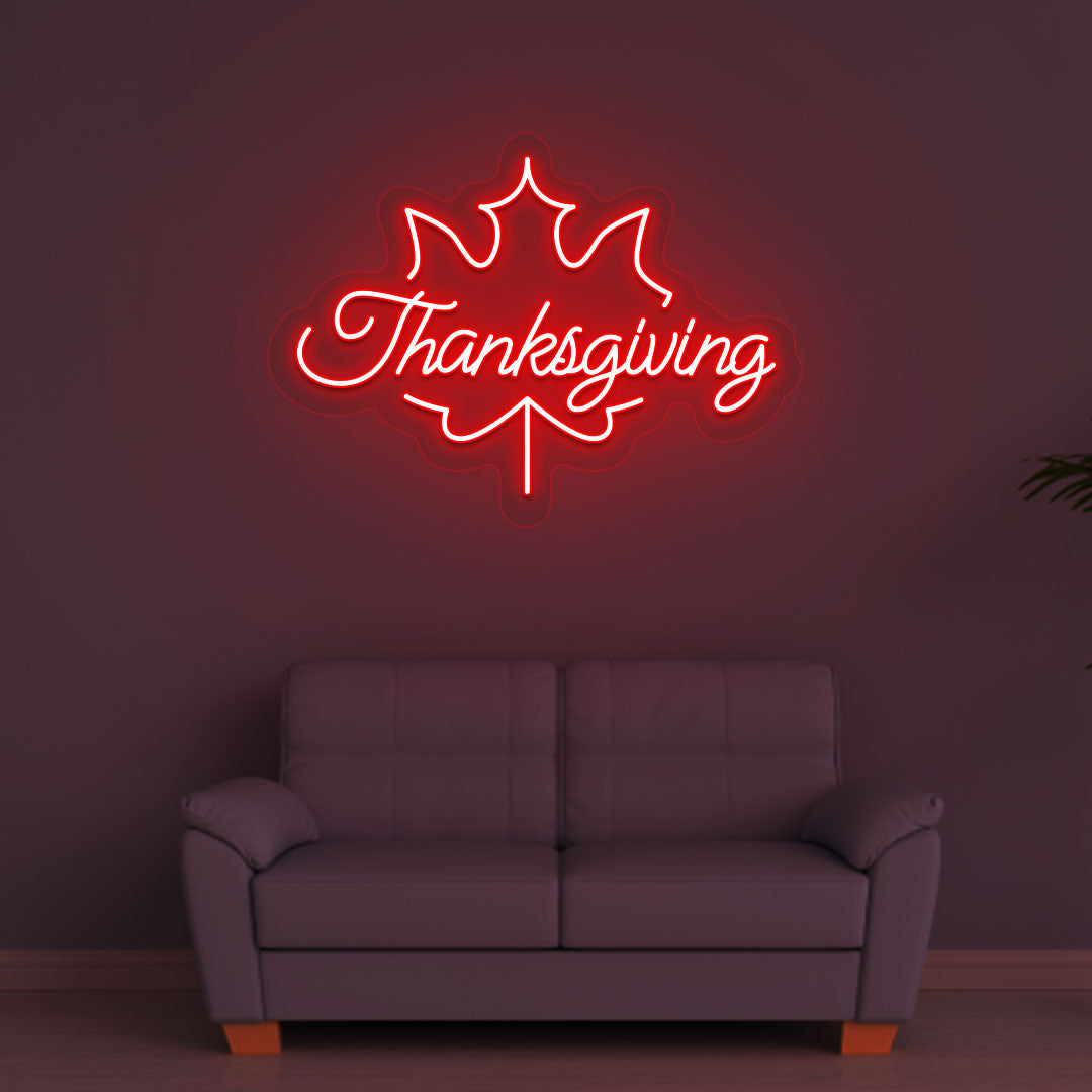Festive season with a Thanksgiving red neon sign glowing on a wall.