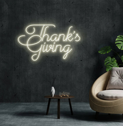 Festive thanksgiving neon sign in warm white mounted on living room wall.