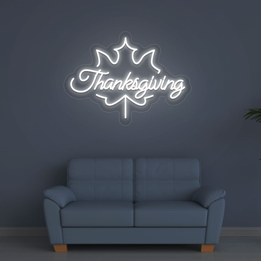 A bright white Thanksgiving neon sign for the holiday hanging on a wall. Perfect for home décor, kitchen walls, and holiday parties.