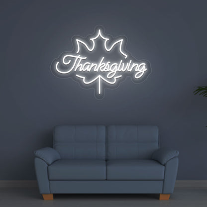 A bright white Thanksgiving neon sign for the holiday hanging on a wall. Perfect for home décor, kitchen walls, and holiday parties.