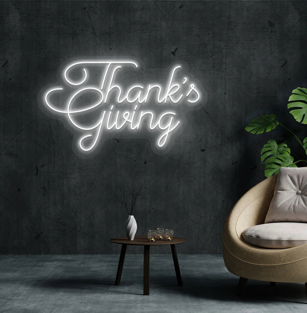 Image of a Thanksgiving neon sign mounted on an aesthetic living room wall in white color.