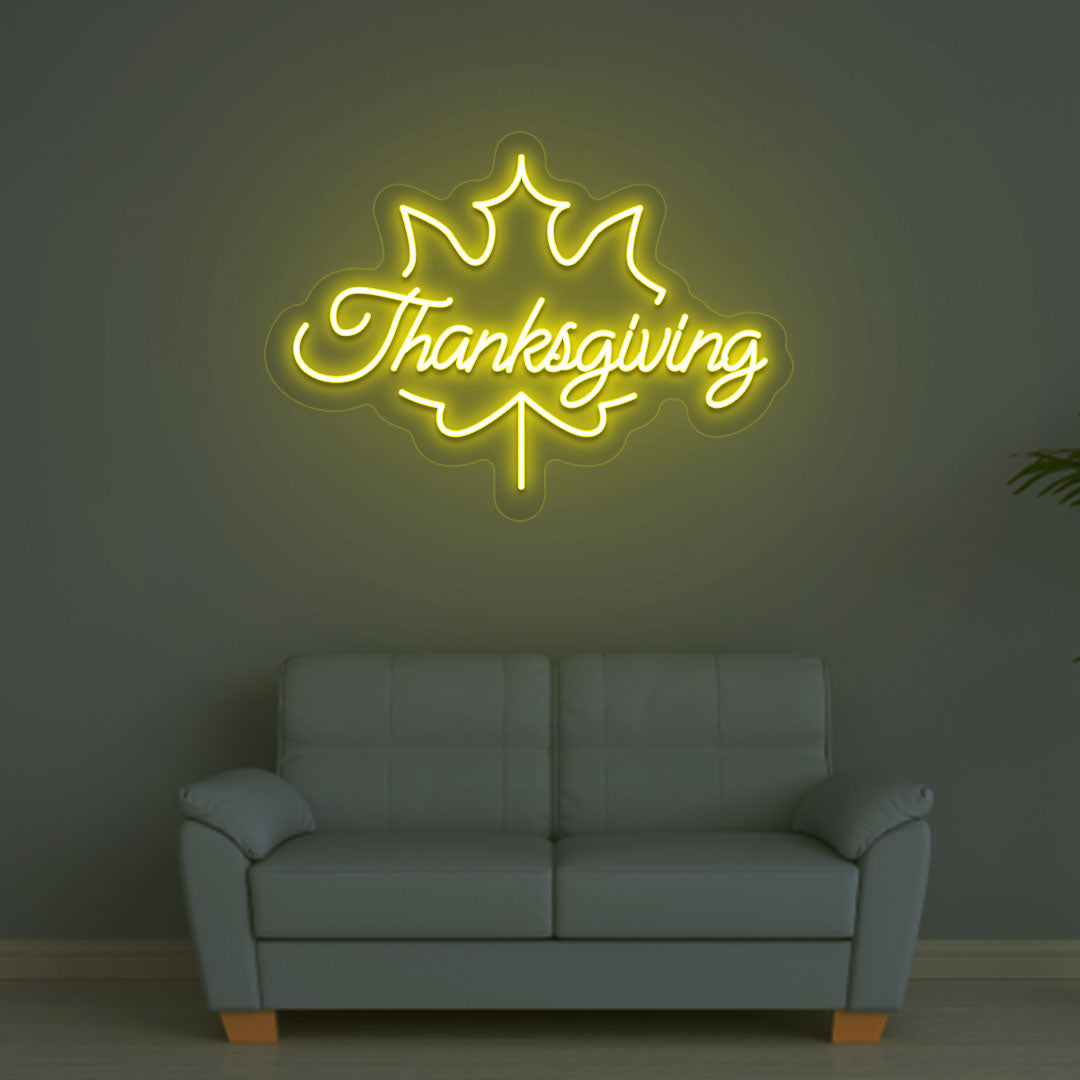 Festive season with a Thanksgiving yellow neon sign glowing on a wall.