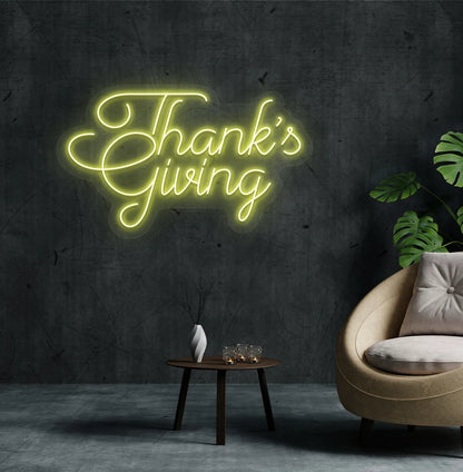Festive thanksgiving neon sign in yellow mounted on living room wall.