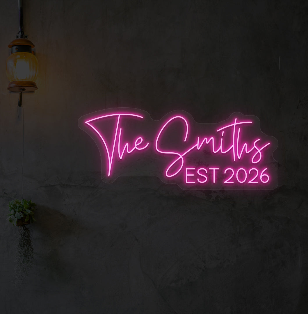 Image of "the Smiths" LED neon sign glowing on wall in pink.