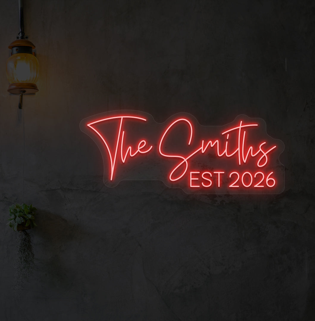 Image of "the Smiths" LED neon sign glowing on wall in red.