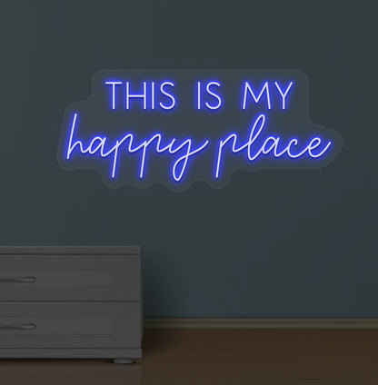 Image of a "this is my happy place" LED neon sign glowing on a wall in blue color.