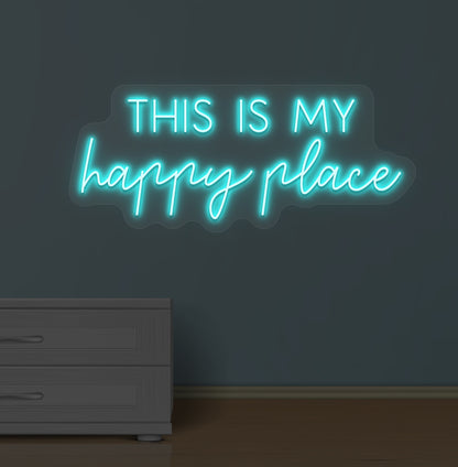 Image of a "this is my happy place" LED neon sign glowing on a wall in ice blue color.