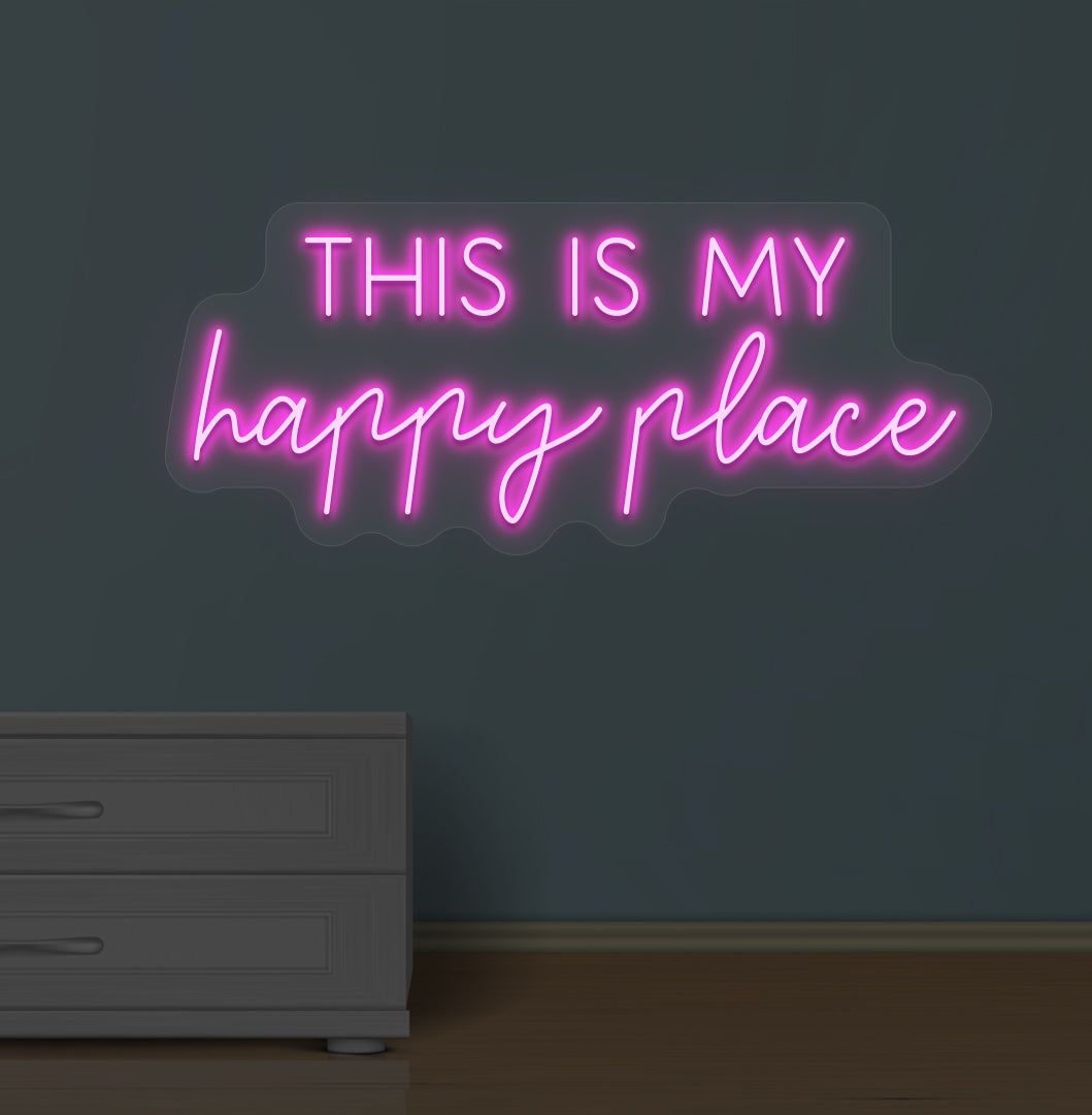 Image of a "this is my happy place" LED neon sign glowing on a wall in pink color.