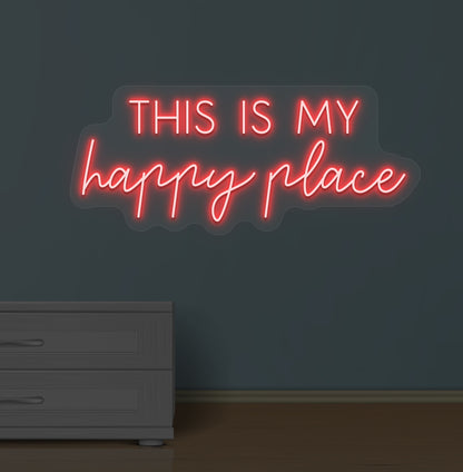 Image of a "this is my happy place" LED neon sign glowing on a wall in red color.