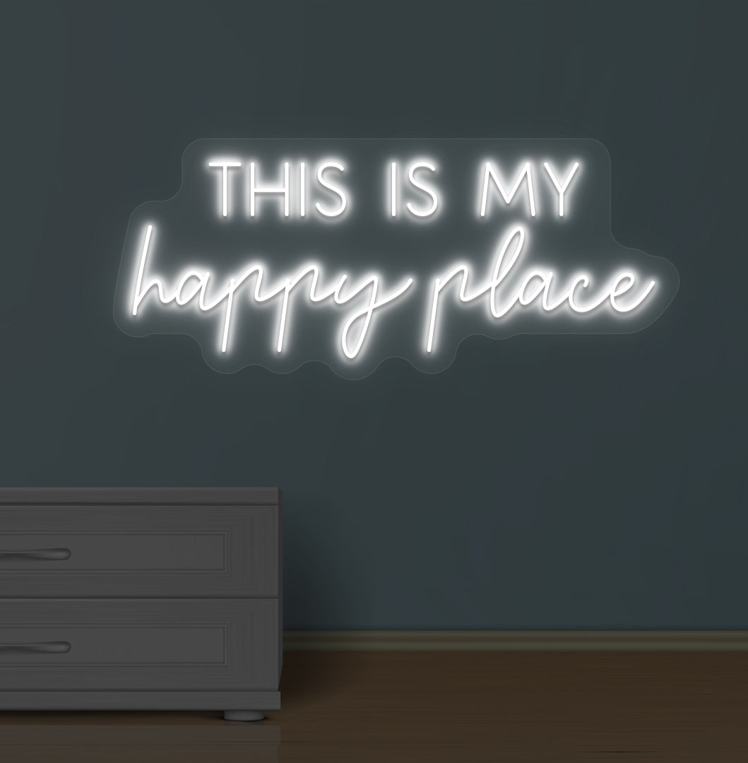 Image of a "this is my happy place" LED neon sign glowing on a wall in white color.