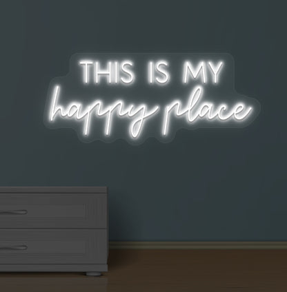 Image of a "this is my happy place" LED neon sign glowing on a wall in white color.