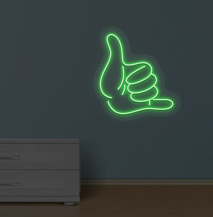 Modern wall with a thumbs-up LED neon sign glowing green.