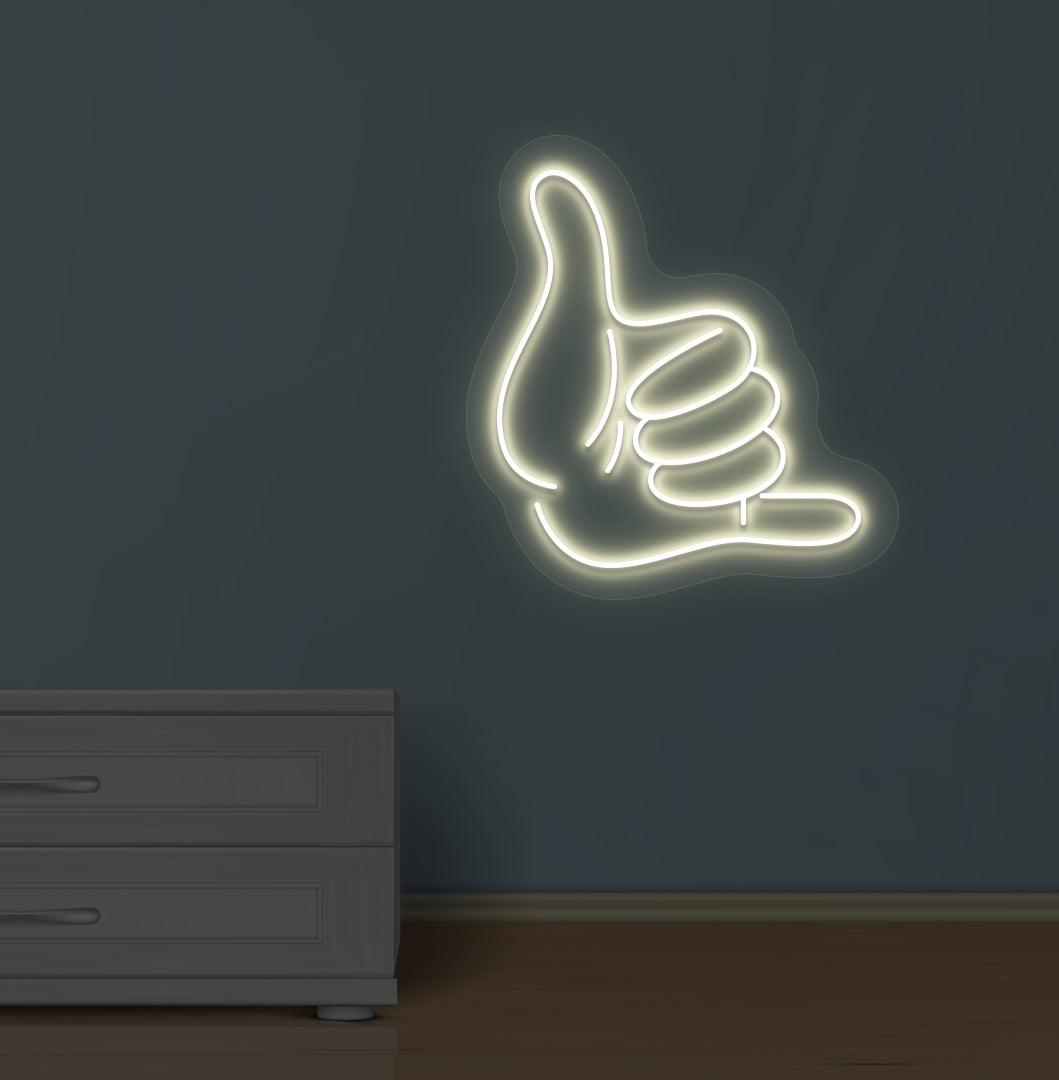 Modern wall with a thumbs-up LED neon sign glowing warm white.