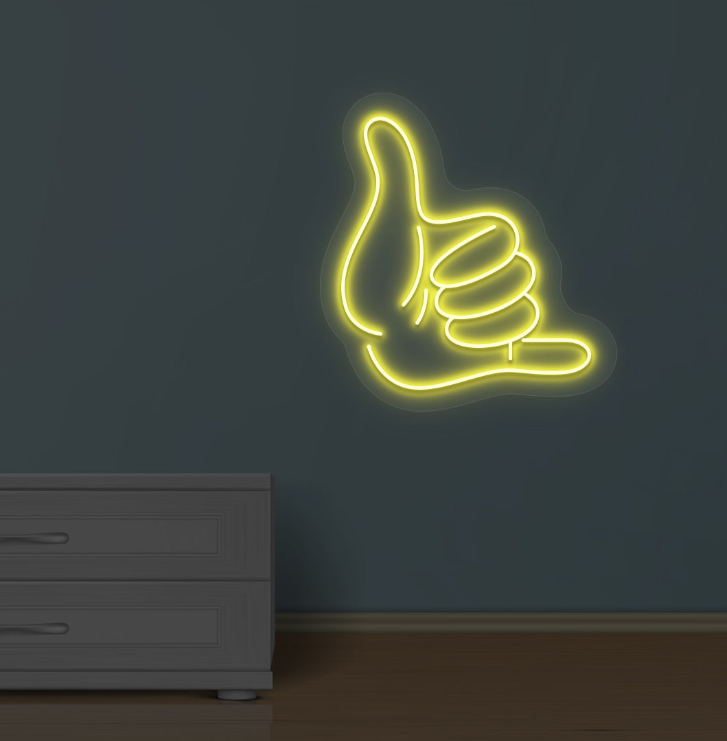 Modern wall with a thumbs-up LED neon sign glowing yellow.