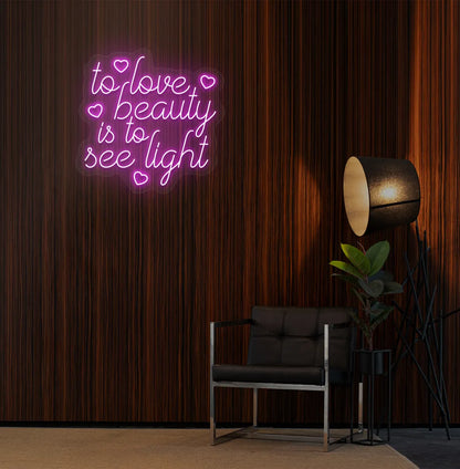 Purple "to love beauty is to see light" LED neon sign for beauty studio setup.