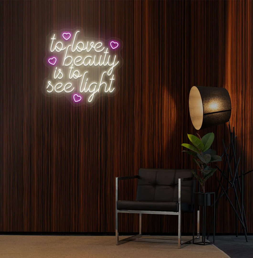 Warm white "to love beauty is to see light" LED neon sign for beauty studio setup.