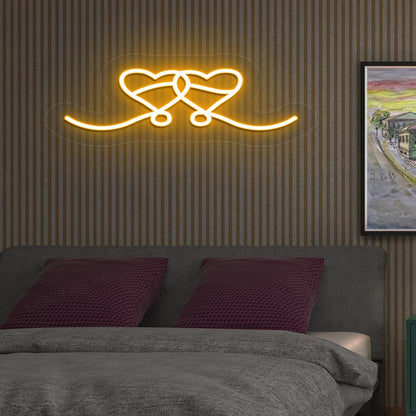 A stylish love theme, two hearts LED neon sign, mounted on the bedroom wall in orange color. perfect for romantic room setups, Valentine's Day decorations, and gifts for couples.
