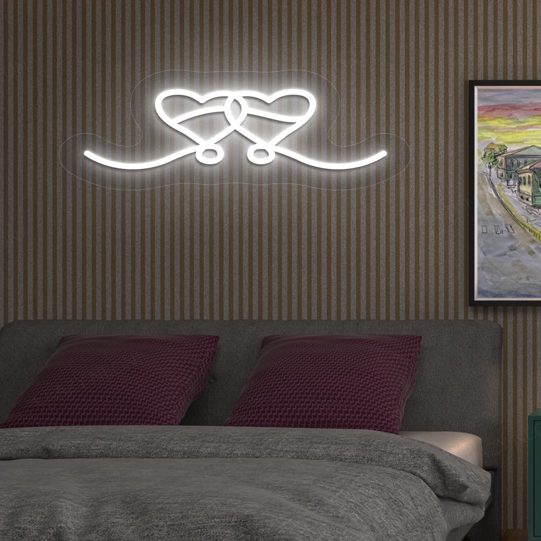 A stylish love theme, two hearts LED neon sign, mounted on the bedroom wall in white color. perfect for romantic room setups, Valentine's Day decorations, and gifts for couples.