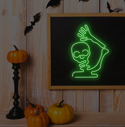Waving Skeleton Green Neon Sign creating a spooky glow on a Halloween themed wall.