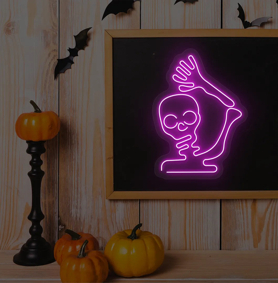 Pink Waving Skeleton Neon Sign glowing on a spooky Halloween themed wall.