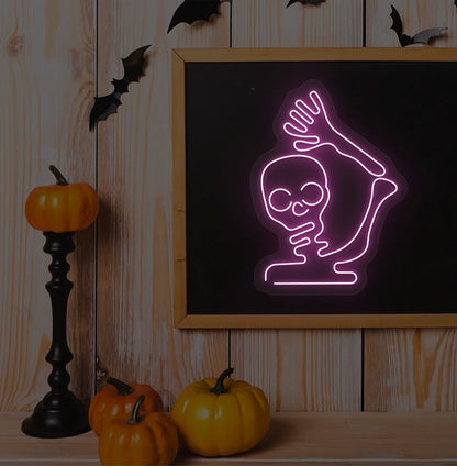 Waving Skeleton Purple Neon Sign creating a spooky glow on a Halloween themed wall.