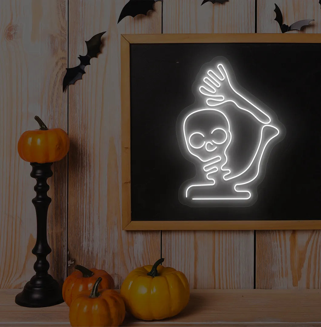 White Waving Skeleton Neon Sign glowing on a spooky Halloween themed wall.